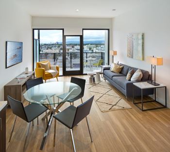 a living room with a glass table and a couch